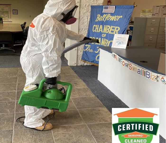 Employee in PPE Cleaning & Disinfecting