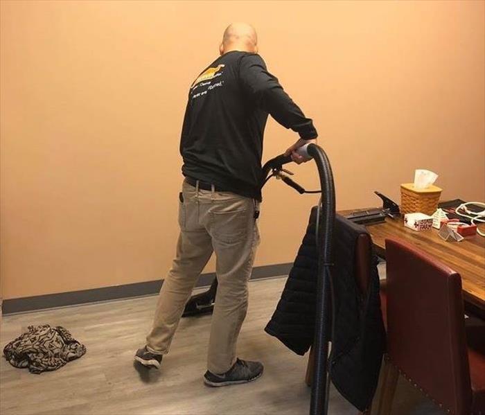 SERVPRO team member is seen extracting water