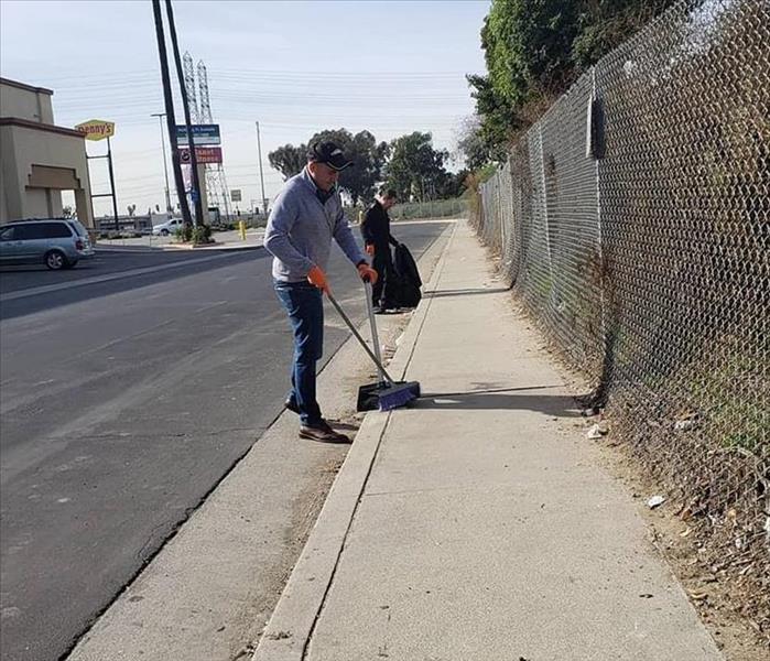 Servpro employees helping clean the dirty areas in our city